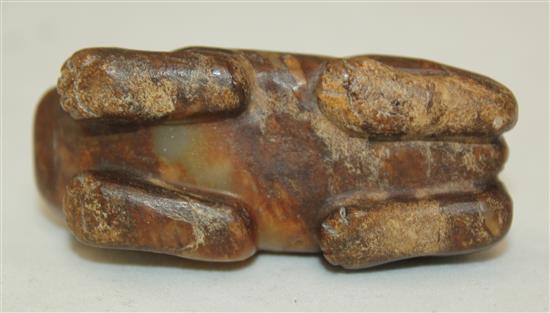 A Chinese celadon and brown jade figure of a recumbent lion-dog, Song dynasty or later, 5.7cm